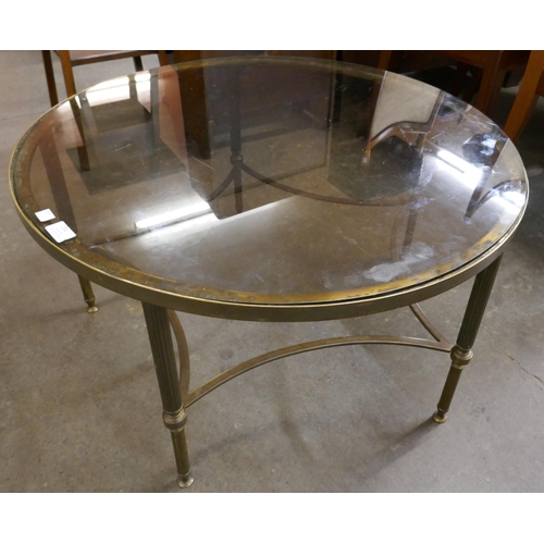 251 - A Hollywood brass and glass topped circular coffee table