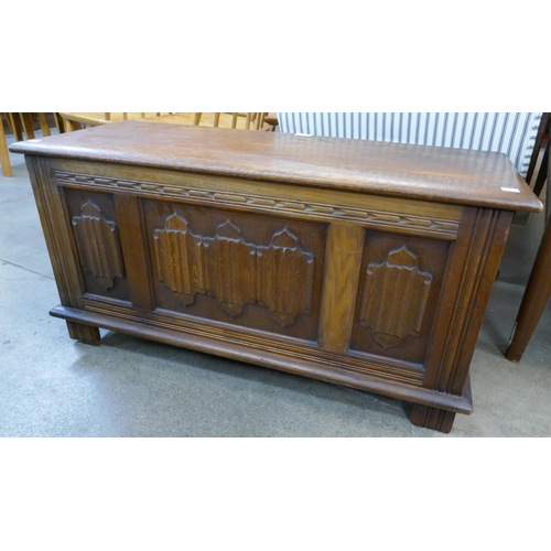 254 - A carved oak linenfold blanket box