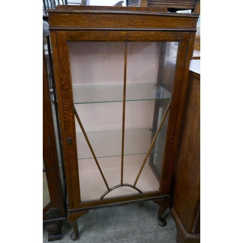 262 - An Art Deco oak single door display cabinet