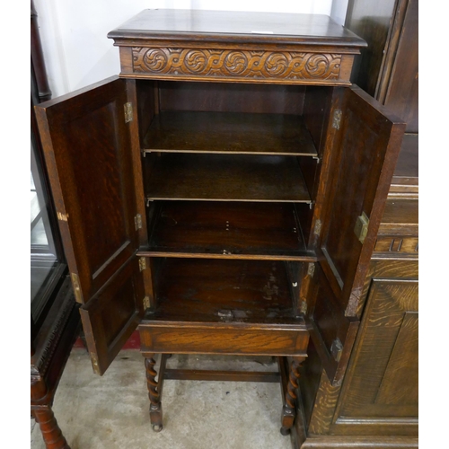 277 - A carved oak barleytwist four door cupboard