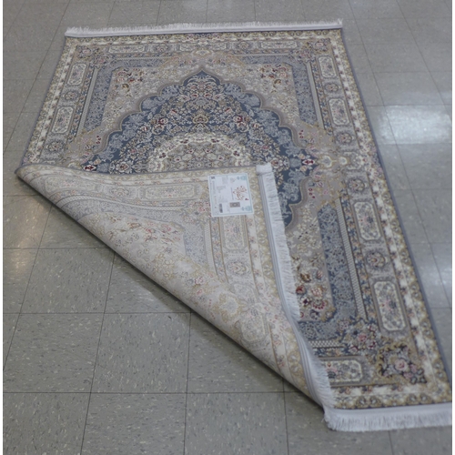 283 - An Iranian beige ground rug, 242cm x 162cm