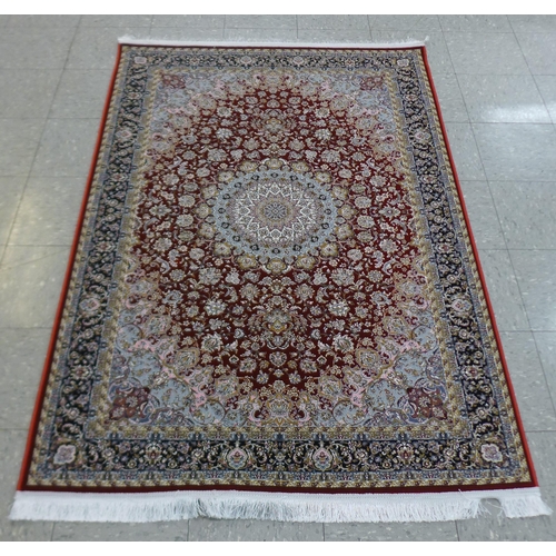 286 - An Iranian red ground rug, 190cm x 121cm