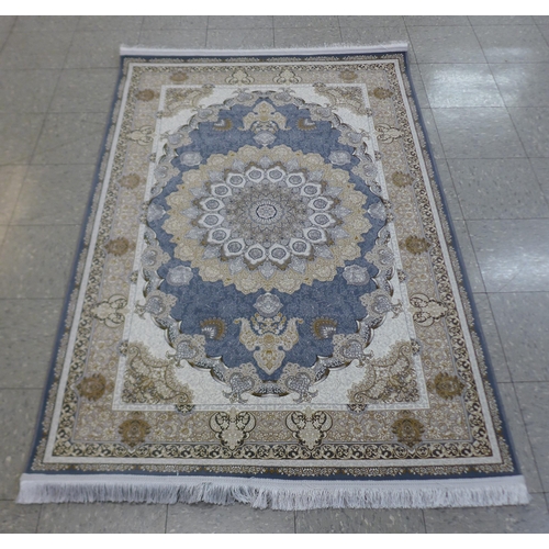 287 - An Iranian beige ground rug, 190cm x 121cm