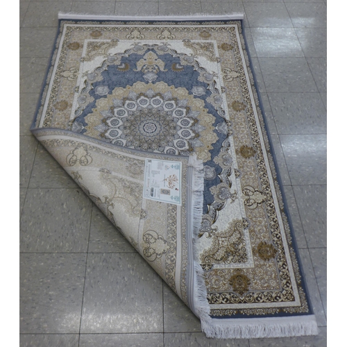 287 - An Iranian beige ground rug, 190cm x 121cm