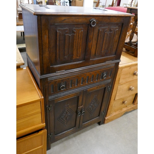 312 - A carved oak linenfold cocktail cabinet