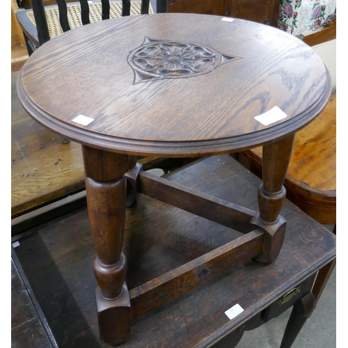 320 - A carved oak cricket style coffee table