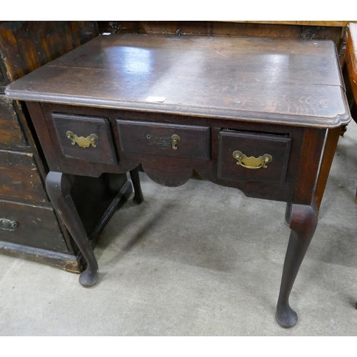 321 - A George III oak three drawer lowboy