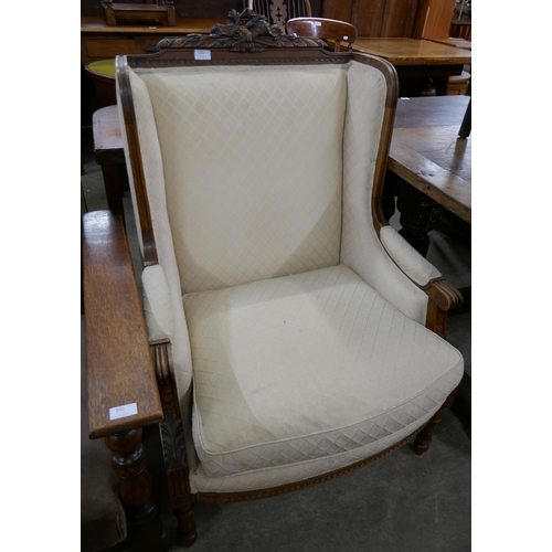 331 - An early 20th Century French carved walnut and fabric upholstered fauteuil chair