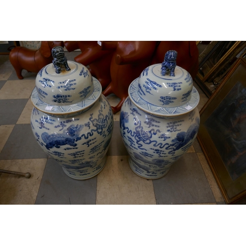 407 - A pair of large Chinese blue and white octagonal stoneware vases and covers