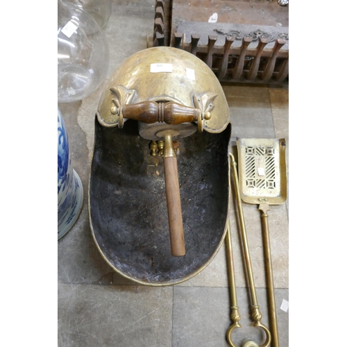 408 - A Victorian brass coal scuttle, a cast iron fire grate and brass companion set