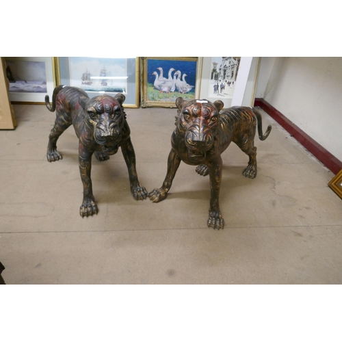 419 - A pair of large bronze tigers of tigers