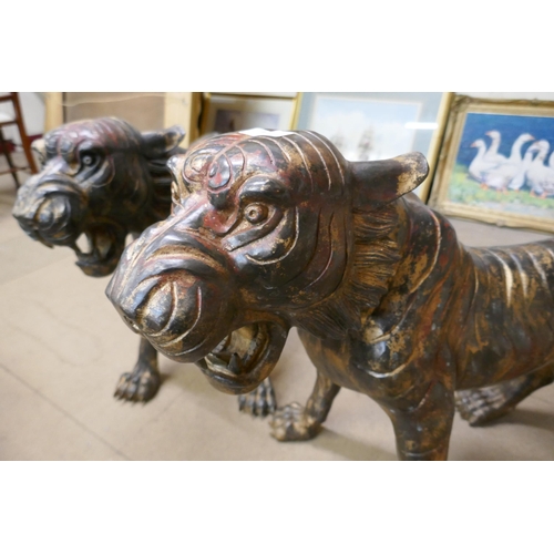 419 - A pair of large bronze tigers of tigers