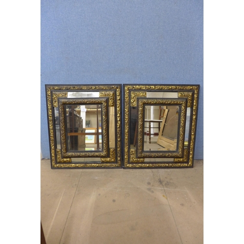 480 - A pair of Victorian ebonised and parcel gilt cushion framed mirrors