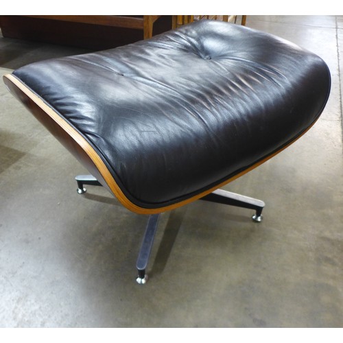 154 - A Charles & Ray Eames style simulated rosewood and black leather revolving lounge chair and ottoman