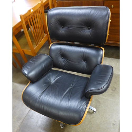 155 - A Charles & Ray Eames style simulated rosewood and black leather revolving lounge chair and ottoman