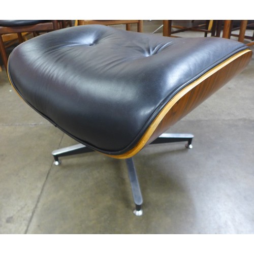 155 - A Charles & Ray Eames style simulated rosewood and black leather revolving lounge chair and ottoman