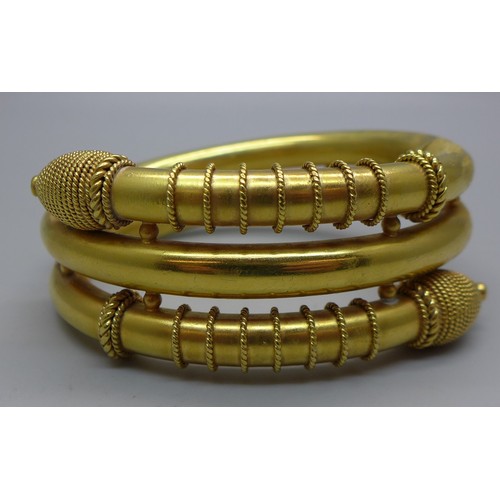 1049 - A Victorian snake style gilt metal bangle with hinge opening, inner dimensions 45mm x 58mm, 61g