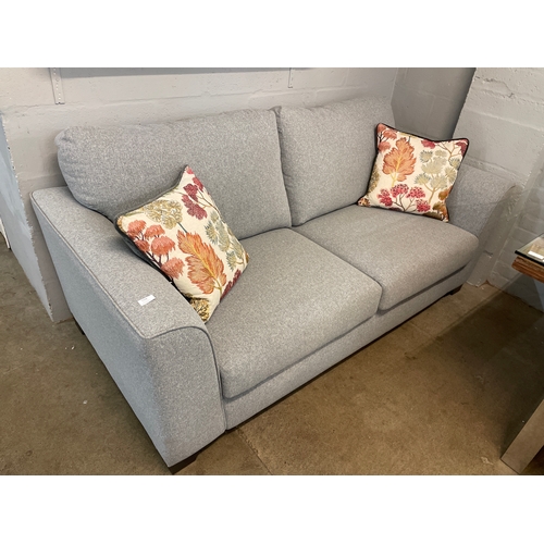 1318 - A mid grey fabric upholstered 2.5 seater sofa