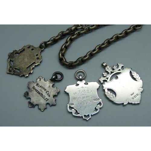 1004 - A silver fob and chain and three other silver fob medals, 54g