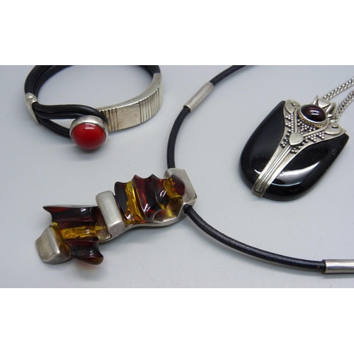 1011 - A silver mounted necklet, two stone set pendants on silver chains and a bracelet