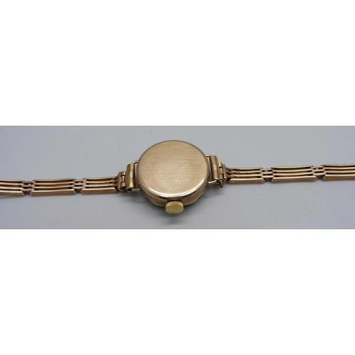 1022 - A lady's 9ct gold cased President wristwatch on a 9ct gold bracelet, weight without movement 10.4g