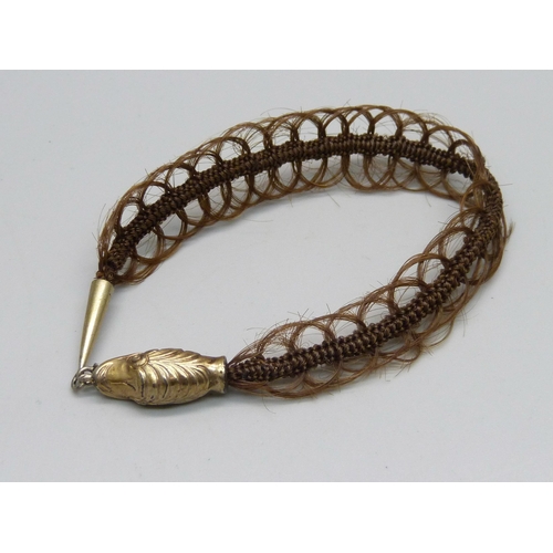 1034 - A Victorian 'hair' bracelet with gilt metal clasp