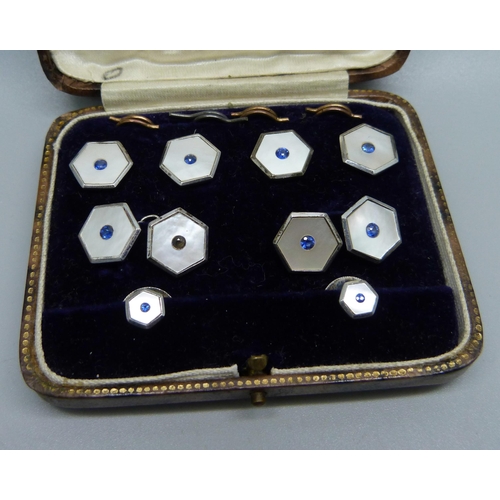 1053 - A cased set of silver, mother of pearl and blue stone studs and cufflinks