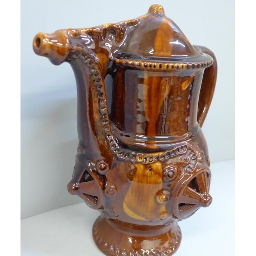 607 - A treacle glaze pottery puzzle jug, 26cm