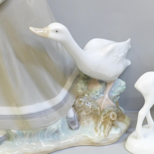 612 - A Lladro figure, girl with geese, 31cm and a German figure of a girl feeding a fawn