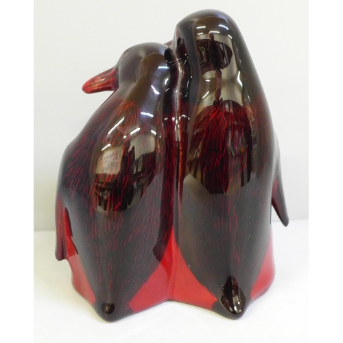 628 - A rare Royal Doulton flambe penguin pair figure group, HN133, 15cm, (fine crack on the bill of the l... 