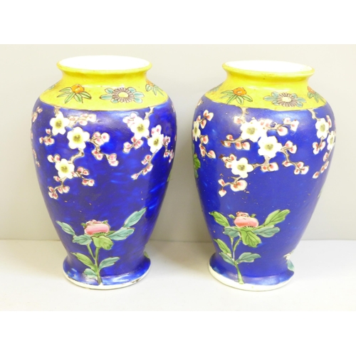 652 - A pair of Japanese blue and yellow vases decorated with birds and flowers, chip to one base, 15cm