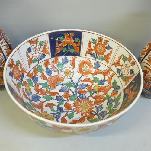 671 - A pair of Imari vases, 25cm, one restored and an Imari bowl with six character mark to base