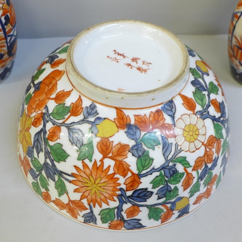 671 - A pair of Imari vases, 25cm, one restored and an Imari bowl with six character mark to base