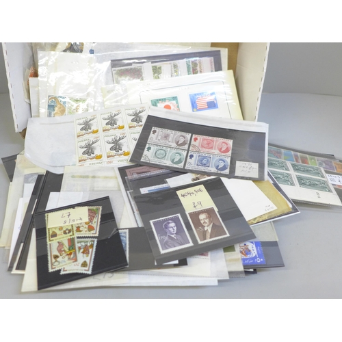 689 - Stamps; a box of world stamps on packets and stock cards