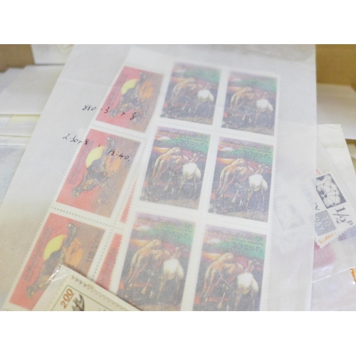 689 - Stamps; a box of world stamps on packets and stock cards