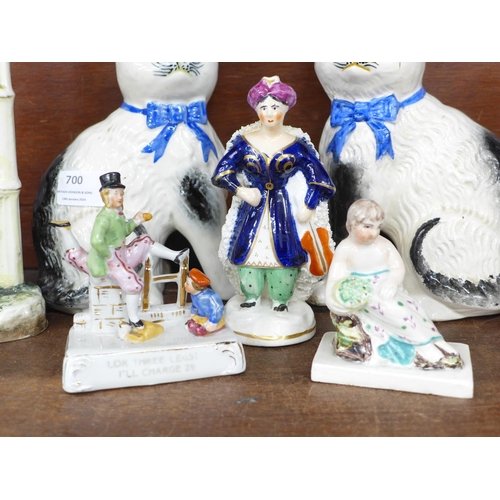 700 - A pair of Victorian Staffordshire cats, a pair of Victorian figural male and female Pierrot specimen... 