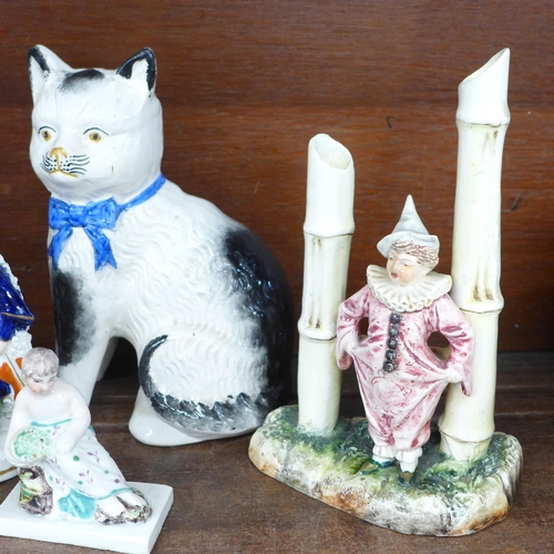 700 - A pair of Victorian Staffordshire cats, a pair of Victorian figural male and female Pierrot specimen... 