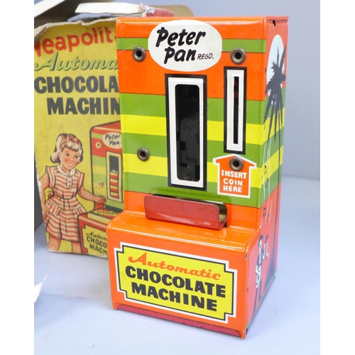 725 - A tin plate Peter Pan chocolate machine, Mettoy play scales, a Merit microscope, all boxed