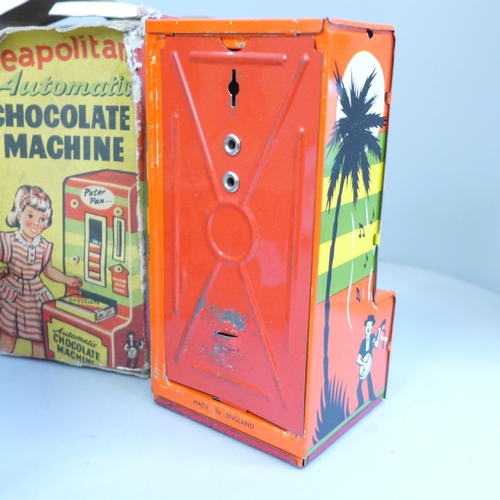 725 - A tin plate Peter Pan chocolate machine, Mettoy play scales, a Merit microscope, all boxed