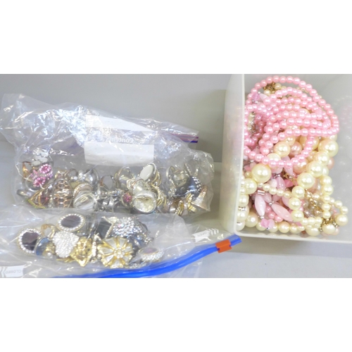 744 - A box of faux pearls, twelve paris of earrings and forty-seven costume rings