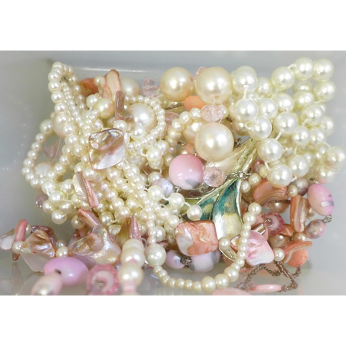 744 - A box of faux pearls, twelve paris of earrings and forty-seven costume rings