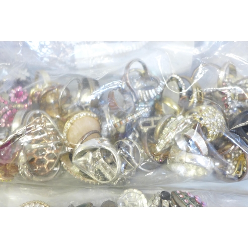 744 - A box of faux pearls, twelve paris of earrings and forty-seven costume rings