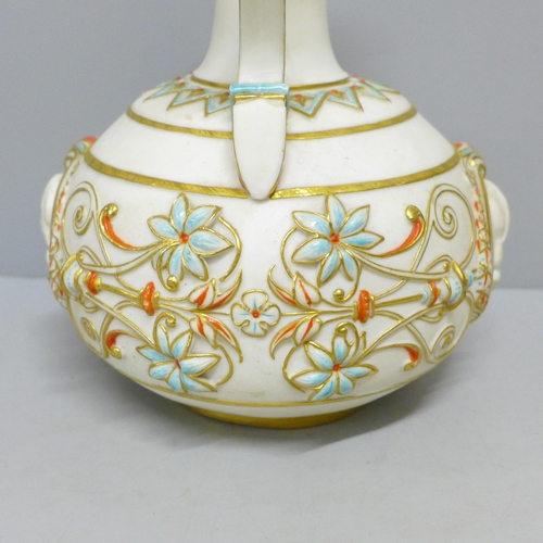 775 - A late 19th Century ewer, decorated in blue, orange and gold against a cream ground with two circula... 