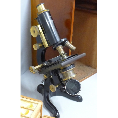 784 - A Watson microscope, cased and a case containing slides, microscope marked Service W. Watson & Sons ... 