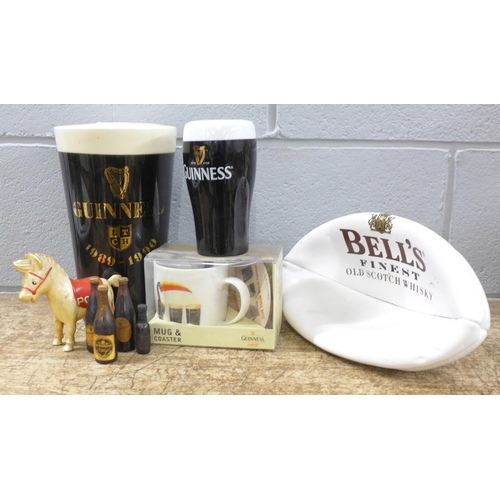 789 - A large pottery Guinness pint glass money bank, one smaller, a Guinness mug and coaster set, boxed, ... 