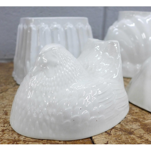 792 - Seven large ceramic jelly moulds including hen, rabbits, fish, rose and lion, two marked Green's and... 