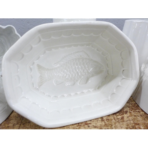 792 - Seven large ceramic jelly moulds including hen, rabbits, fish, rose and lion, two marked Green's and... 