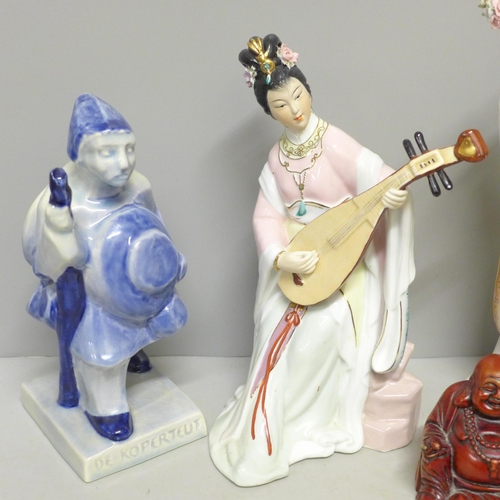 793 - A Delft figure, two oriental figures and a Buddha figure