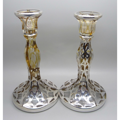 811 - A pair of silver covered glass candlesticks, 19cm,(lacking some silver detail)