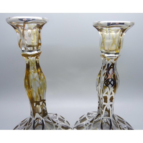 811 - A pair of silver covered glass candlesticks, 19cm,(lacking some silver detail)